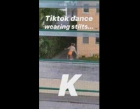 Woman orange shorts stilts dance tiktok video front yard