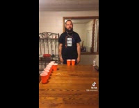 Guy makes joke during beer pong game