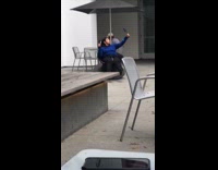 girl blue shirt rolling around chair selfie