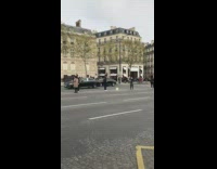 Tourists stand in line in middle of street