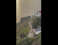 Couple on stairs stand close to each other santorini sunset