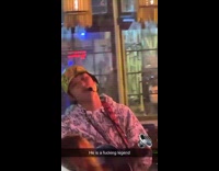Man in bar sings out of tune