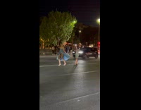 Girl does runway walk in middle of street