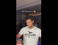 Guy hollister shirt smiling texting on phone toy gun on head