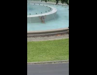 Girl bikini wall bend over water fountain