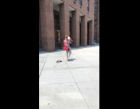 Guy carries dog on shoulders while walking feet 