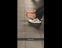 Person takes feet out of white shoes 