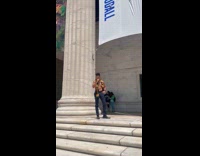 Man shirtless with black university scarf booth