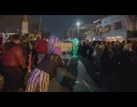 Man takes picture and video of the parade in the middle of the street
