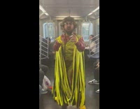 Man in yellow and red cowboy costume drinking