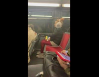 woman with grey ear muffs and giant rubix cube