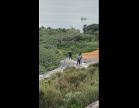 Blonde girl stretch arms mountain ocean boat