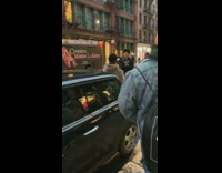 Guy raps in front of car and is recorded by photographer 