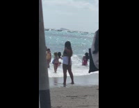 Woman pink bikini sexy pose ocean wave fail