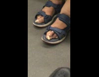 Woman wearing sandals on subway train has ugly looking feet, huge crooked big toe