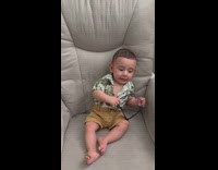 Baby boy takes of sunglasses slowly