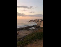 Kids playing near 2 women wearing bikinis
