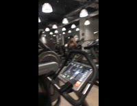 Girl uses the elliptical exercise machine gym