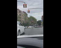 Man ride tall unicycle cross the street
