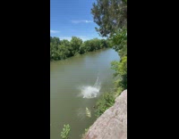 Guy jumps off cliff and bellyflops into water