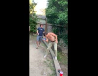 Guy struggling to smash beer can shown up by friend