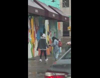 Girl beanie jacket music video street mural