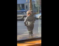 Orange shirt lady poses with tree guy 