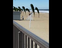 Person lays backwards on white lifeguard chair 