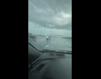 Man drive three wheeled motorcycle freeway rain