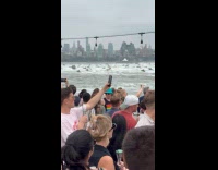 Crowd at party boat watching jetskis