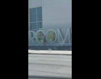 Girl pose behind letter O yellow glass