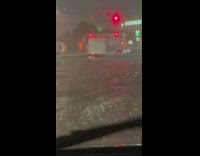 Truck drives through flood at night 