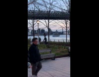 Guy balance tire on head while biking