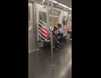 Person sleeps on subway with open umbrella 