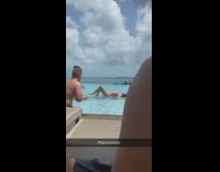 woman helps pose her friend laying on pool