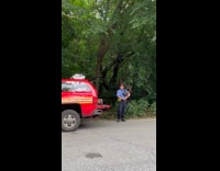 Fireman play bagpipes beside FDNY truck park