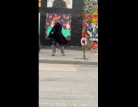 Collab IITW - Man black coat dances on the sidewalk