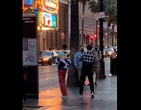 Two guys unsynchronized dance street hollywood lights 