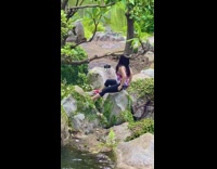 Lady takes self timer photo in garden