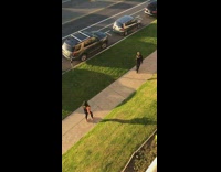 Girl orange sleeves dance sing on sidewalk