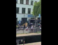 Three people dance beside railings ice wharf