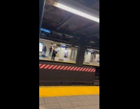 Shirtless man carry speakers play music in subway