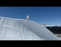 11 year old kid snowboarding on superpipe doing tricks