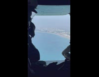 Two men rides airplane with opened back