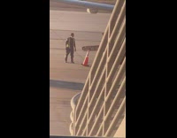 Guy flips orange cone airport runway employee