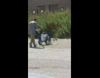 Guy spray paints yellow parking lot lines 