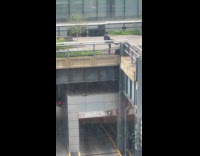 Guy dance at park watched by officer