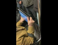 Woman sticks arm in front of mans face to hold  handrail and gets in a fight on subway train