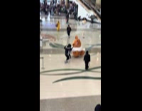 Guys follow Eevee mascot runs around venue