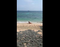 Woman bikini dances at the beach shore